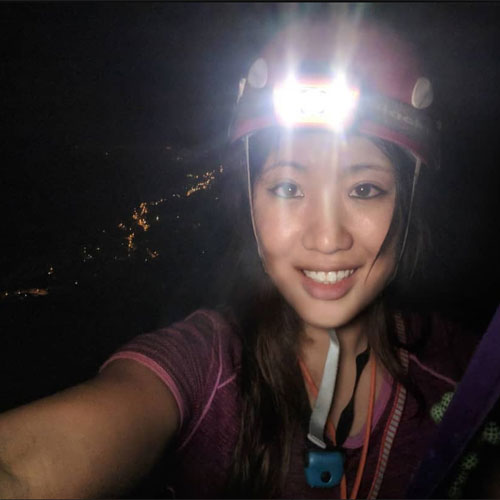 Angi Kim wearing our merino fusion 160 thermal top whilst rock climbing